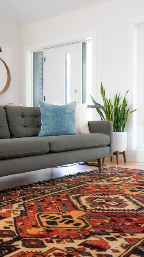 Modern living room furniture in Asaba, featuring a stylish grey sofa with a blue cushion